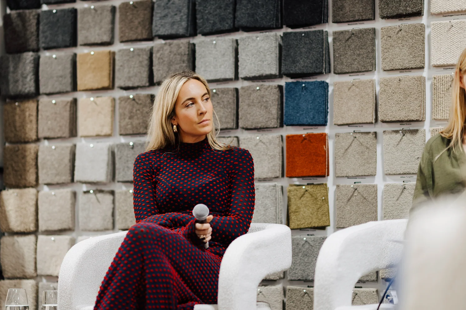 Amy Shaw speaking at an event, seated with a microphone